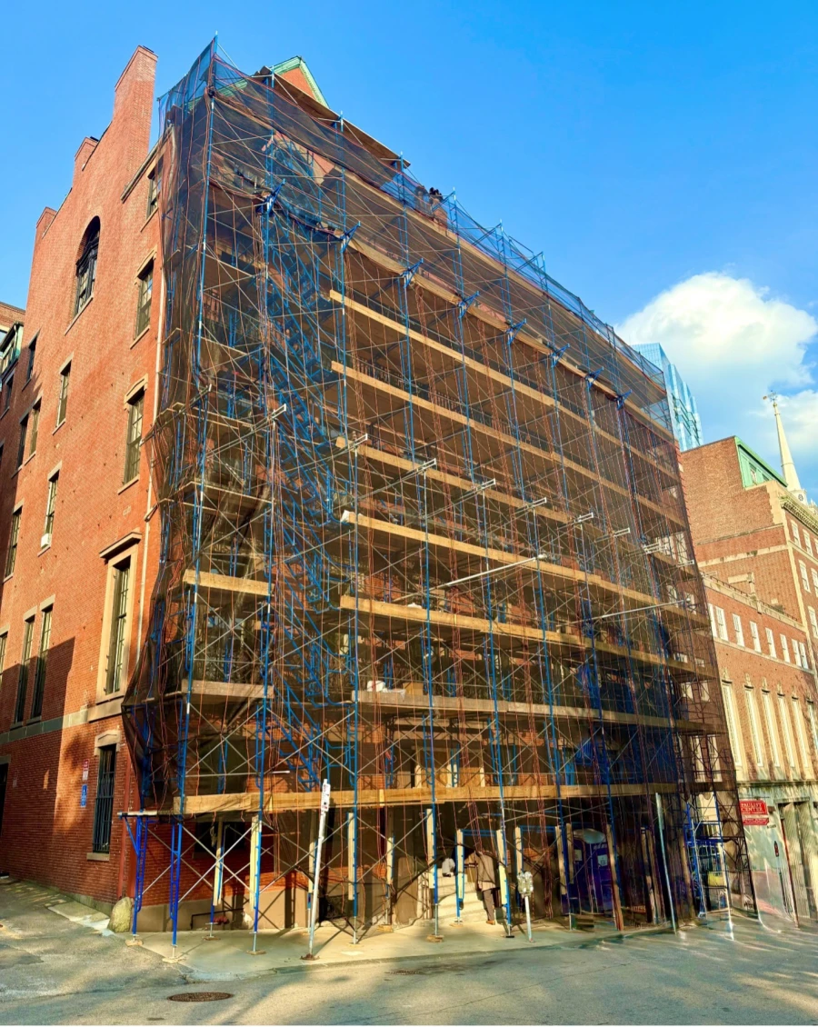 Scaffolding covering the exterior of a brick building.